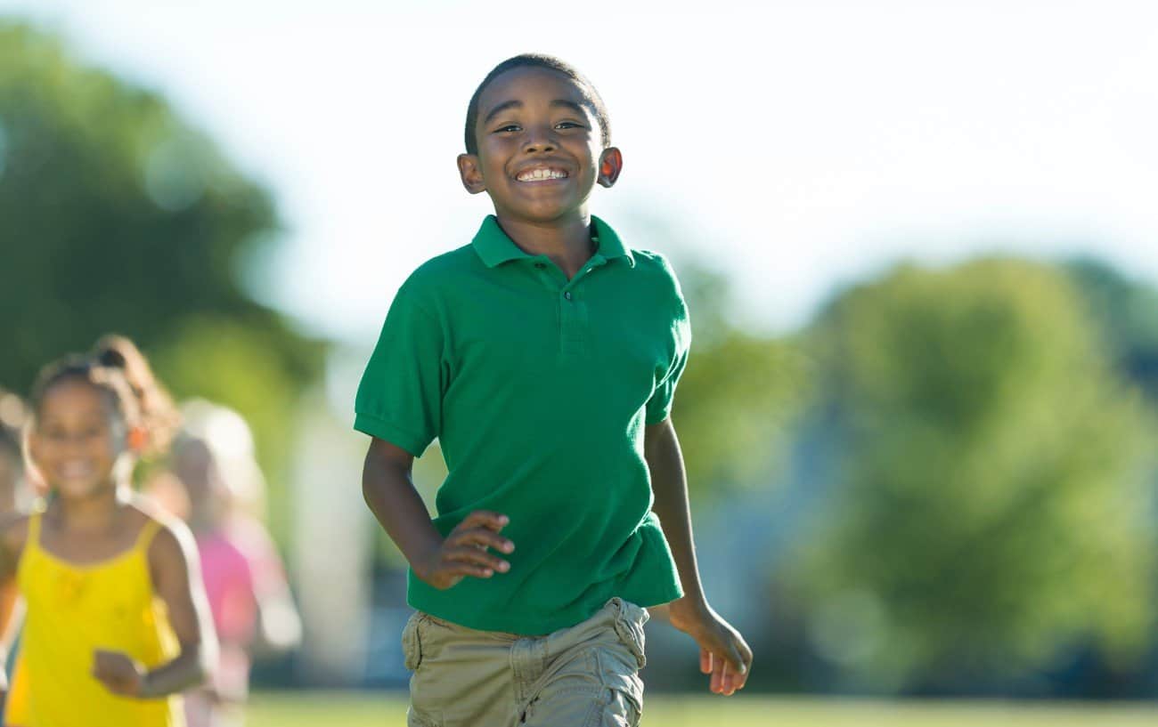 boy running and smiling.