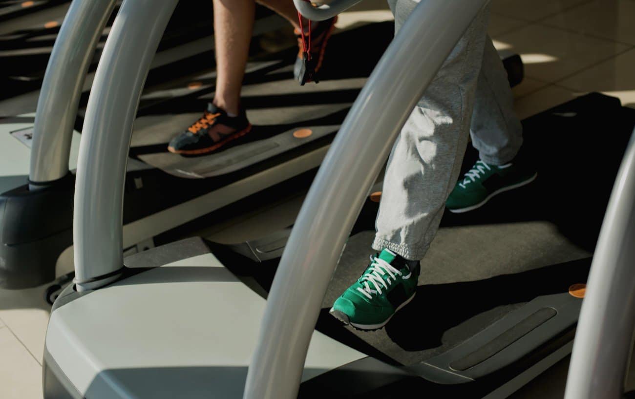 Peoples feet on treadmill.