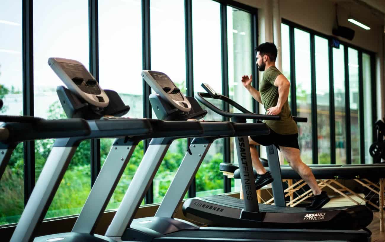 Man running on a manual treadmill.