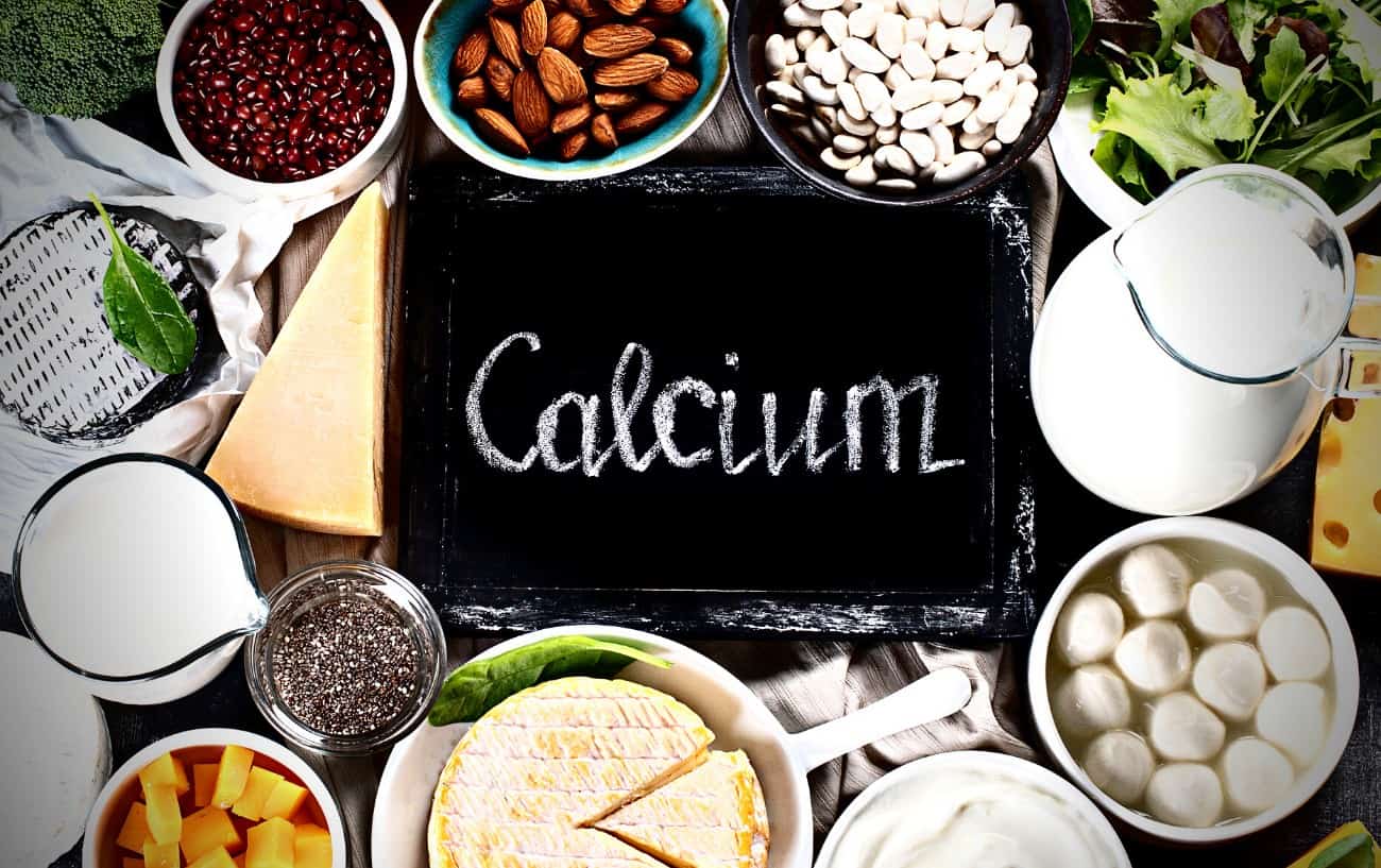 A sign that says "calcium", nuts, milk, beans, and cheese. 