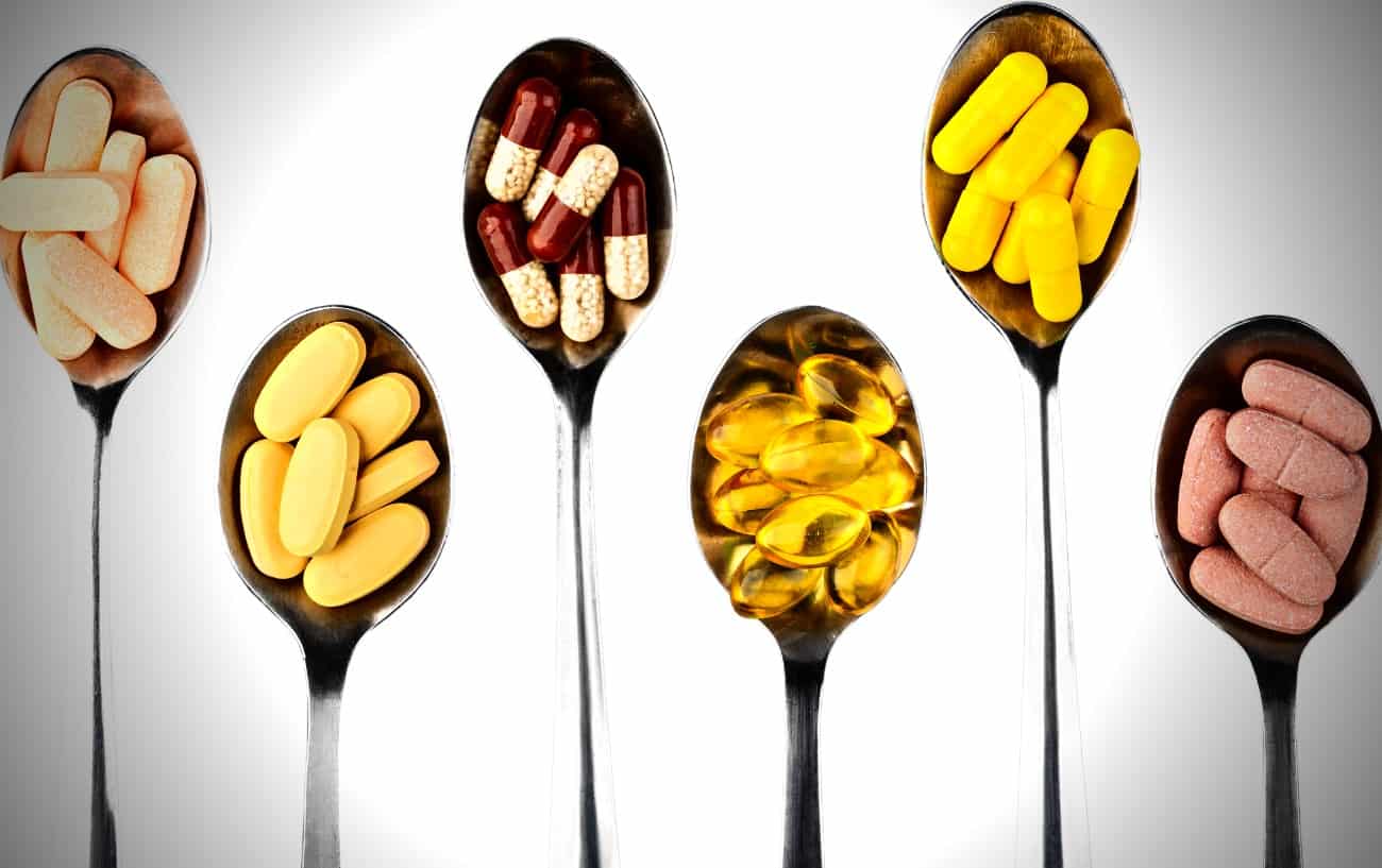 Six spoons filled with different supplements for runners. 