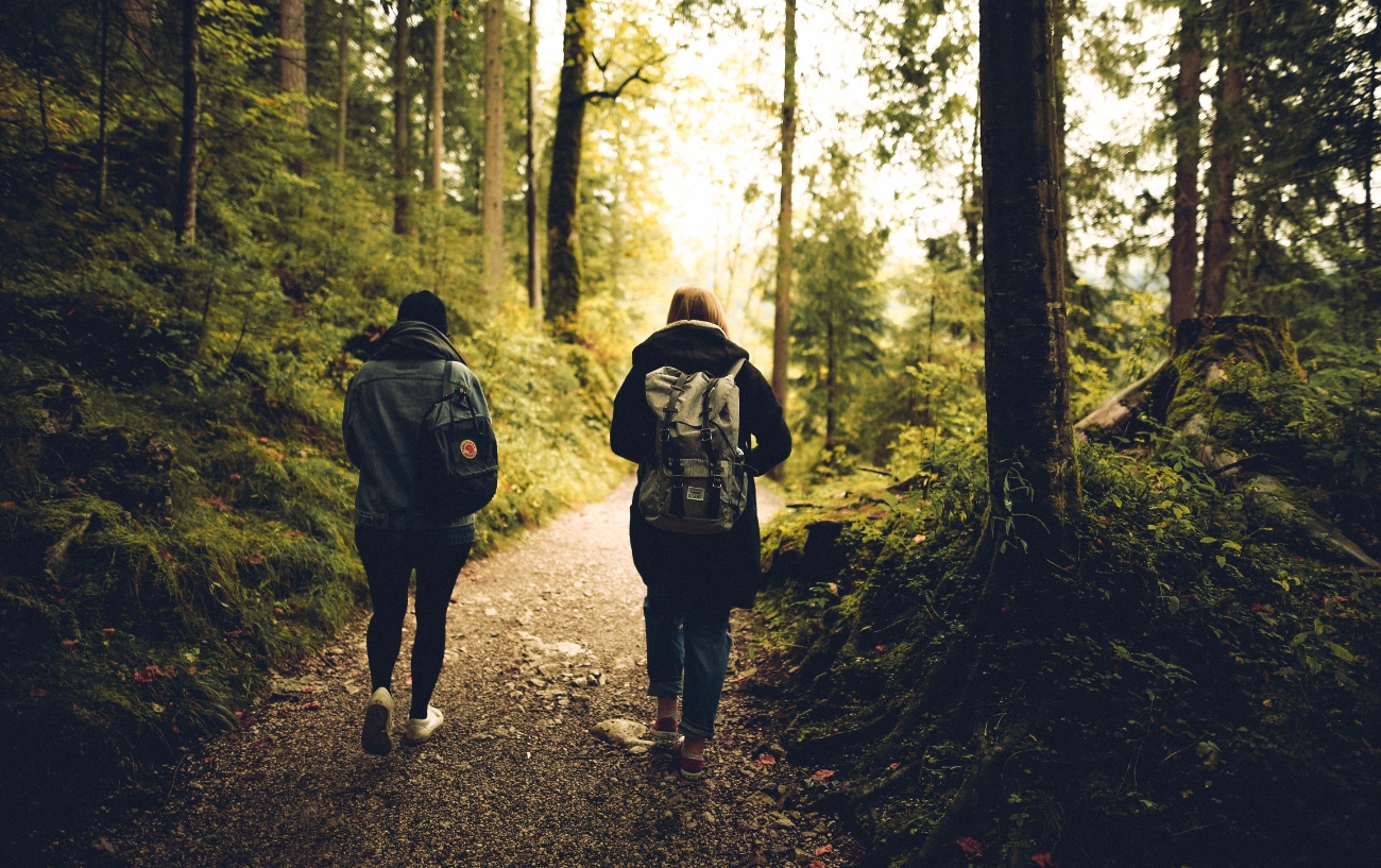 Two women walking in forest