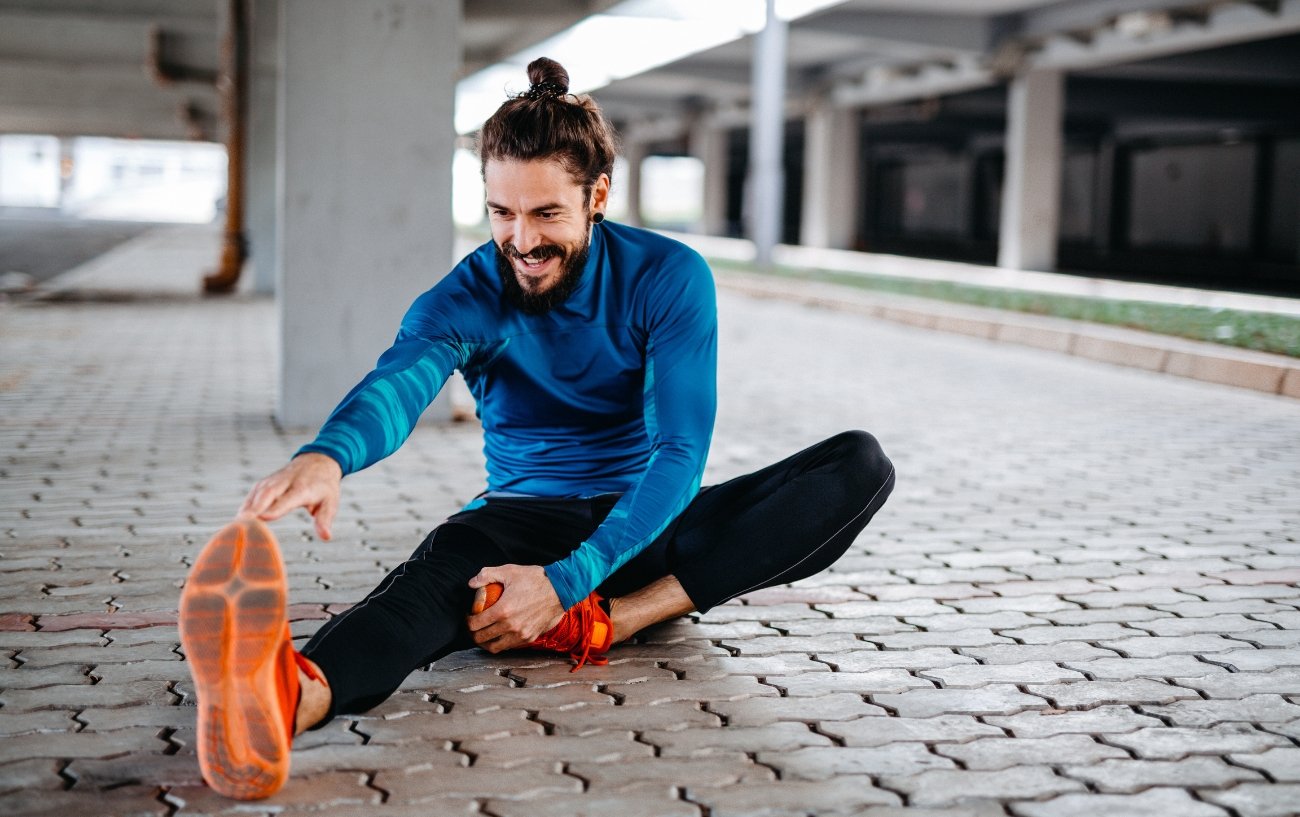 Man stretching on concrete