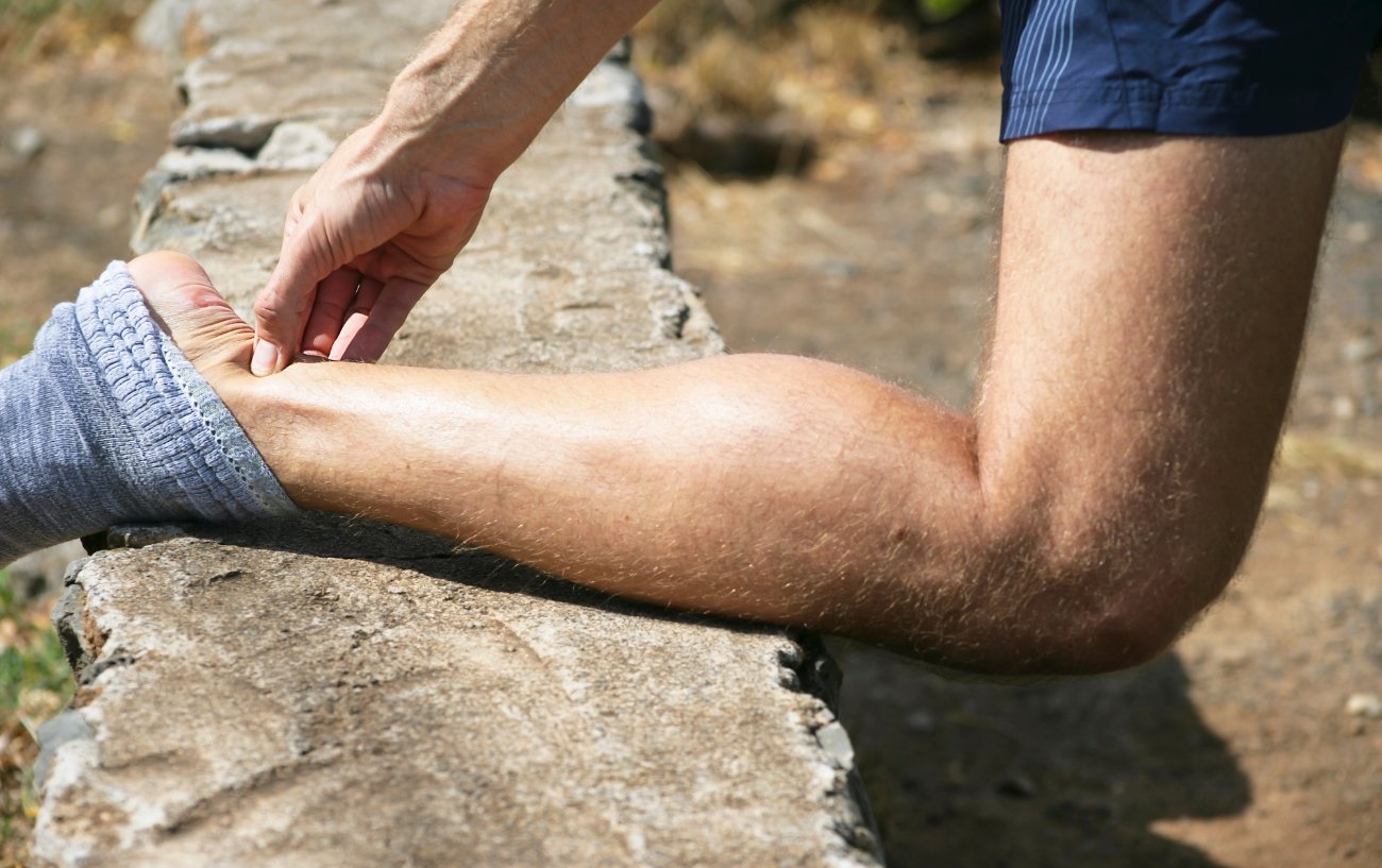 Closeup of man struggling with Achilles Tendonitis 