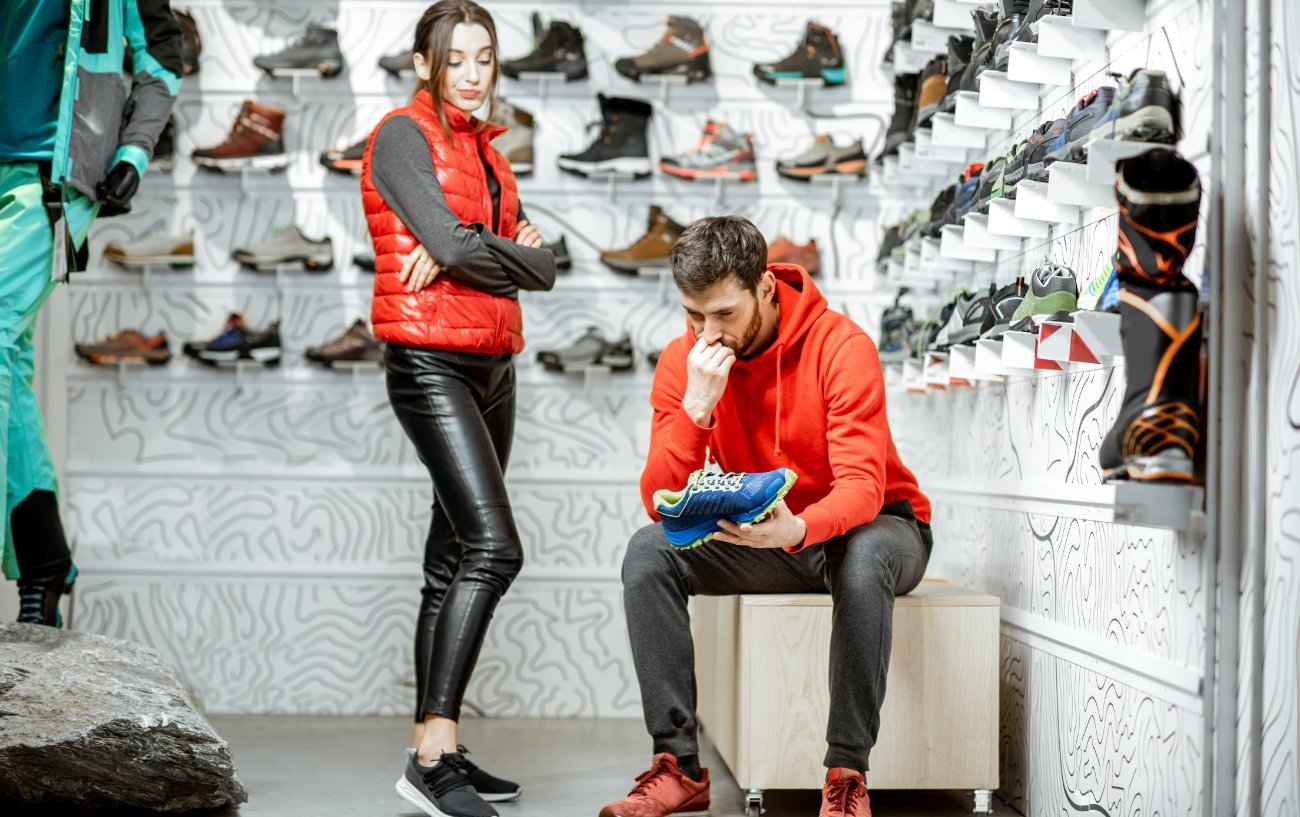 Man contemplating on buying running shoes