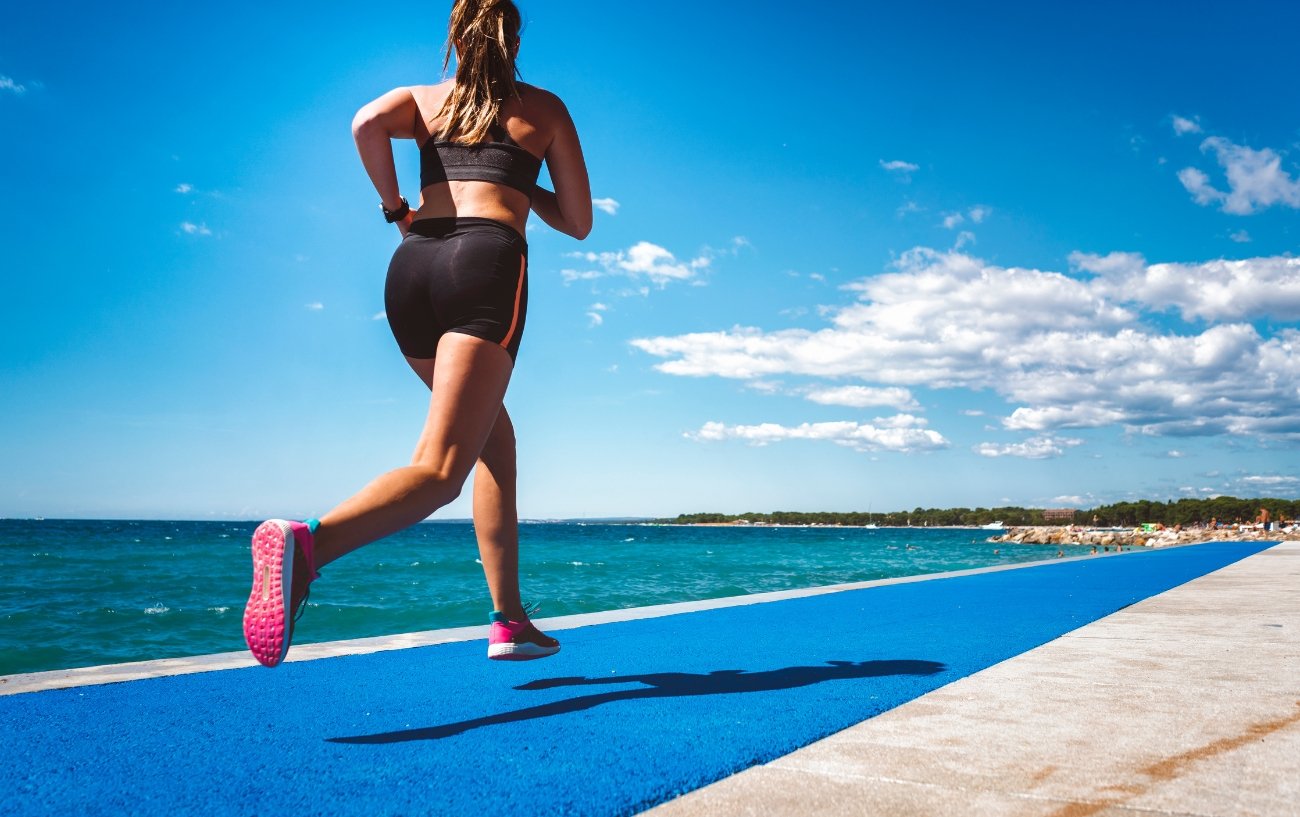 Woman running next to sea