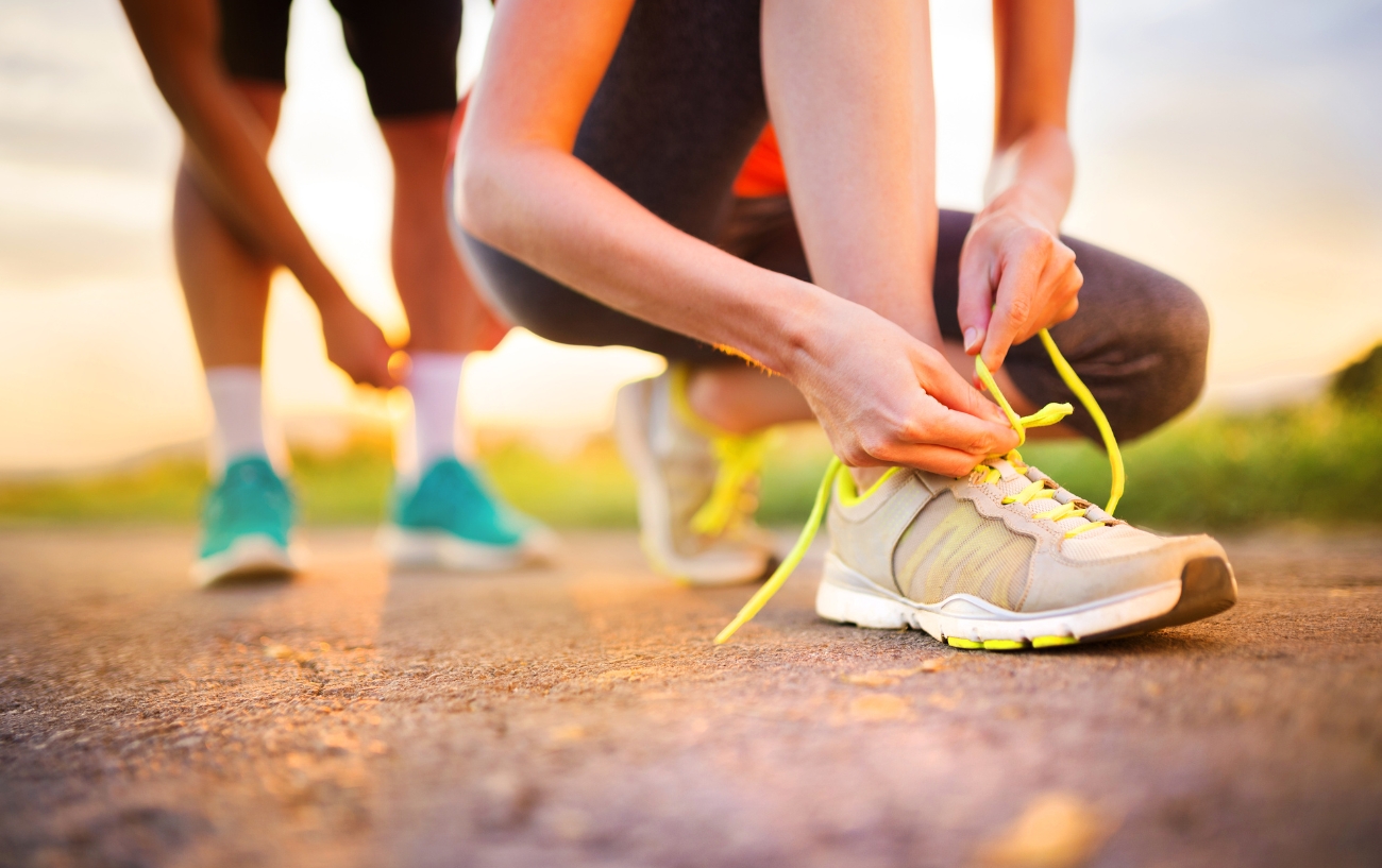 woman tying arch support shoe