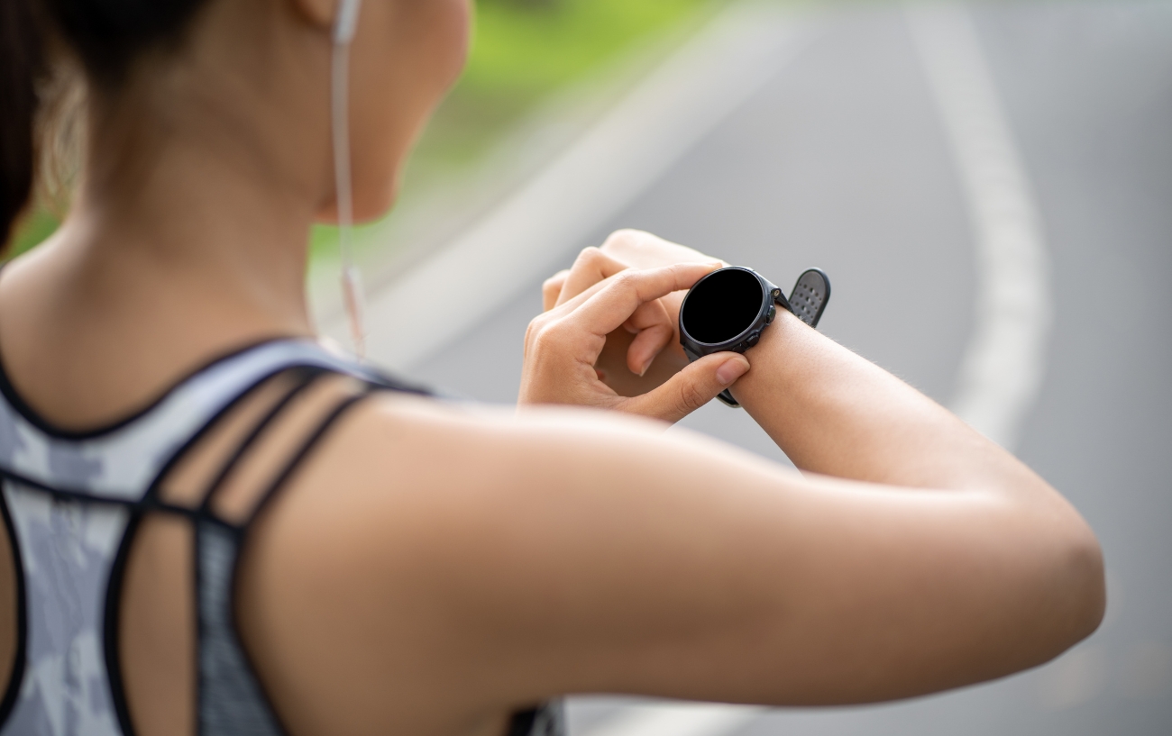 woman looking at her running watch