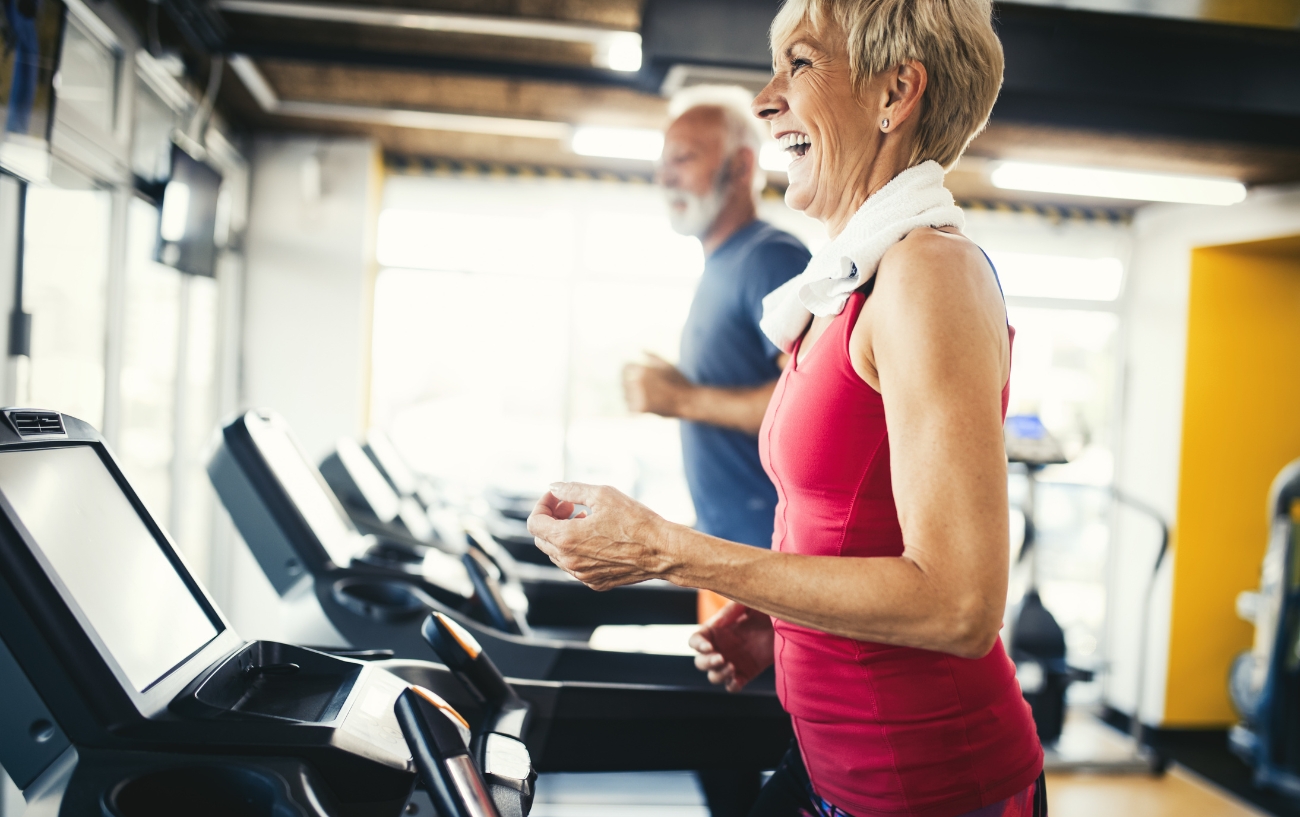 senior woman laughing on treadmil
