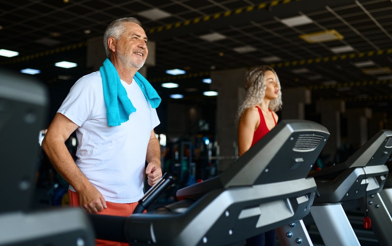 Happy senior man on treadmill