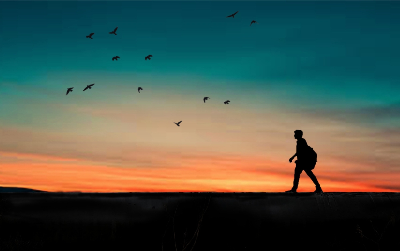 man walking in sunset