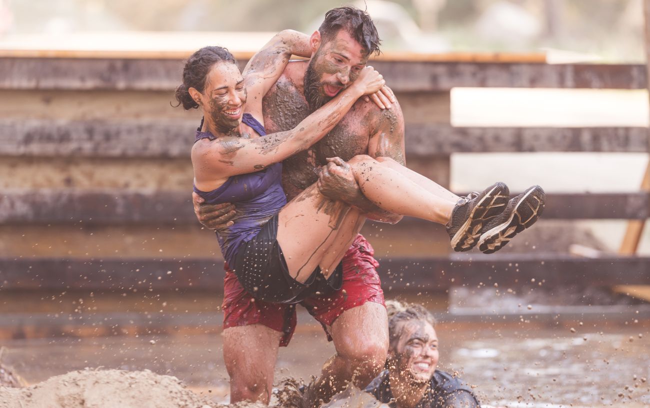 people having fun running in mud